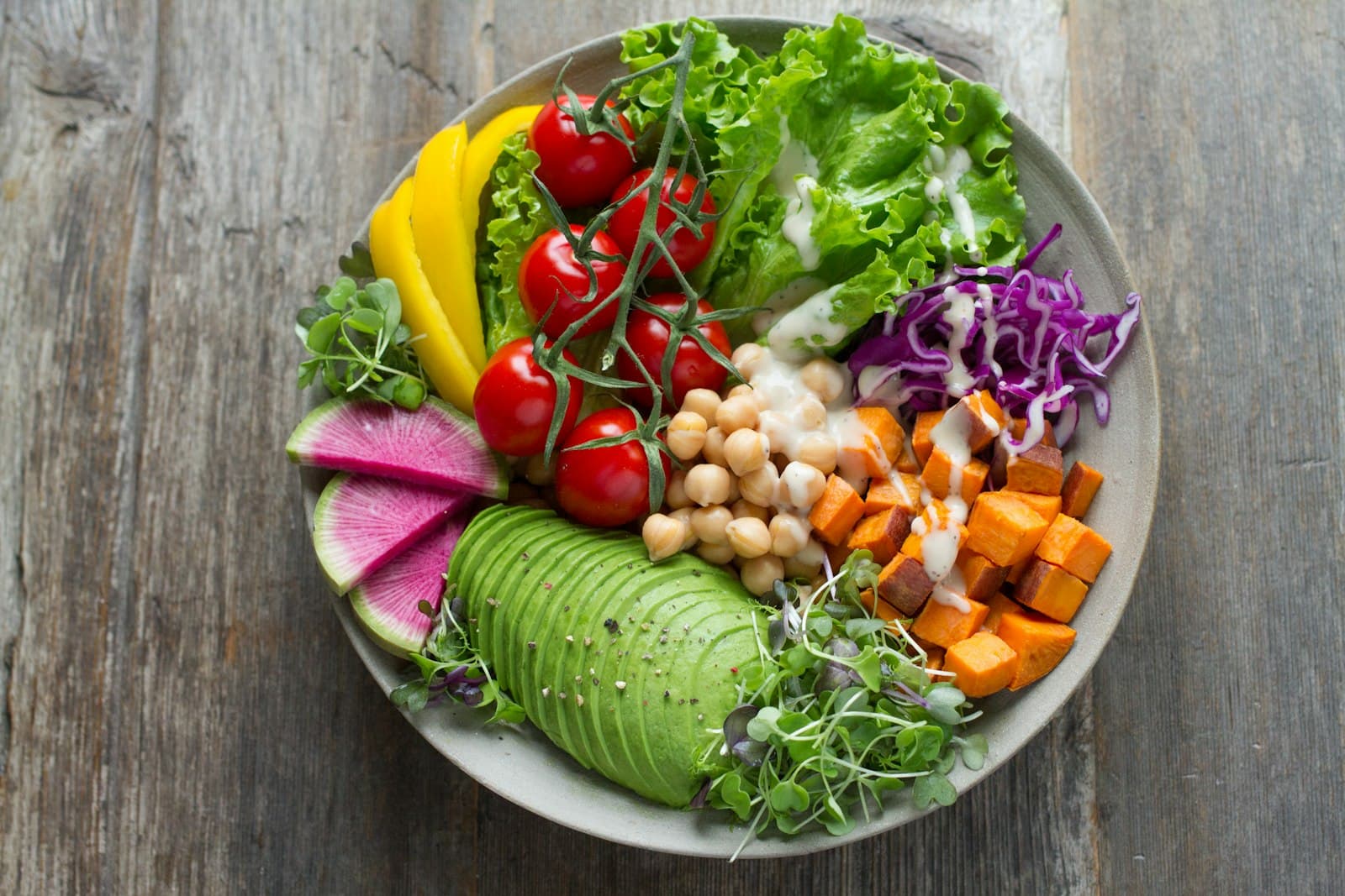 A colourful bowl of fresh vegetables and grains