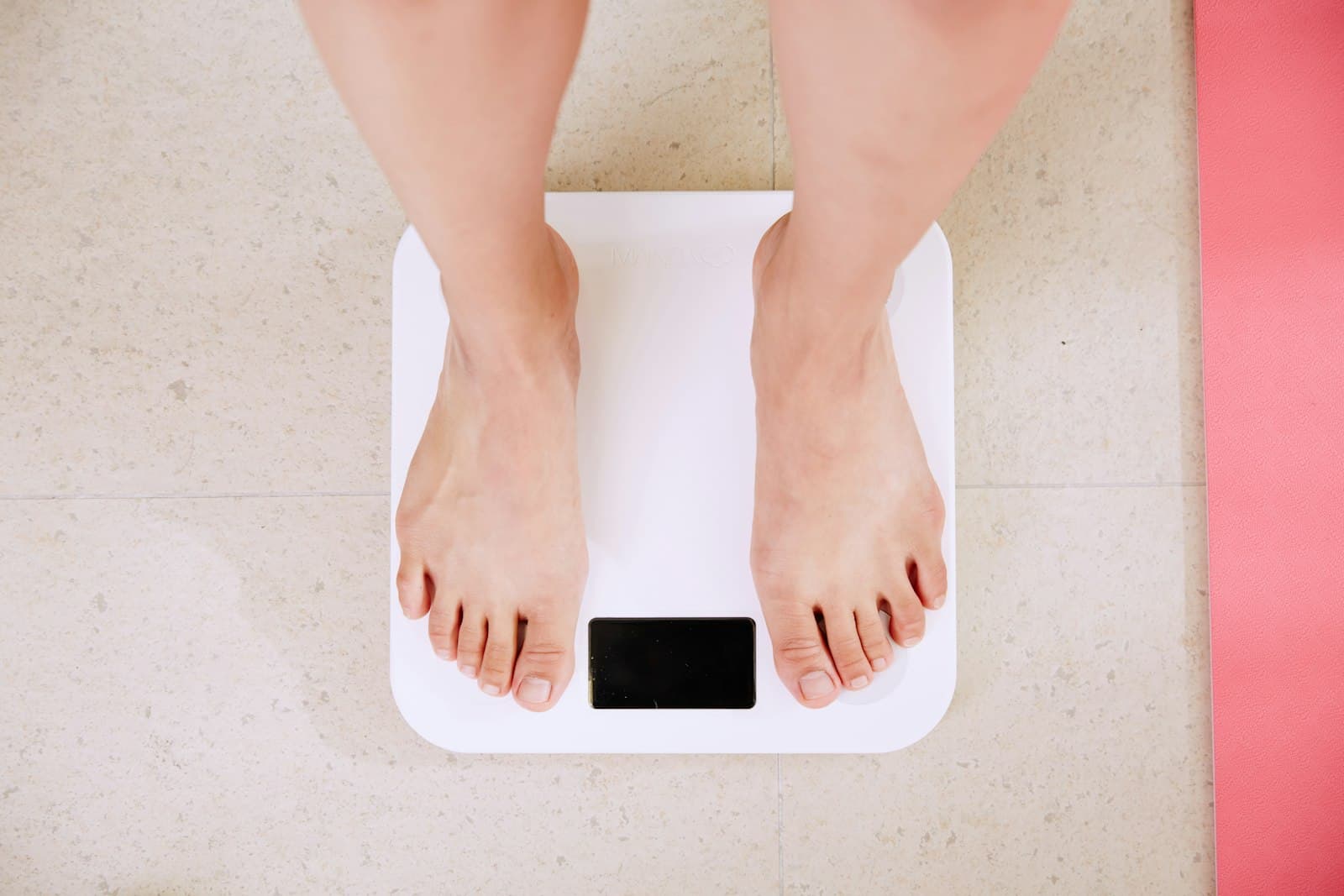 Bare feet standing on a bathroom scale