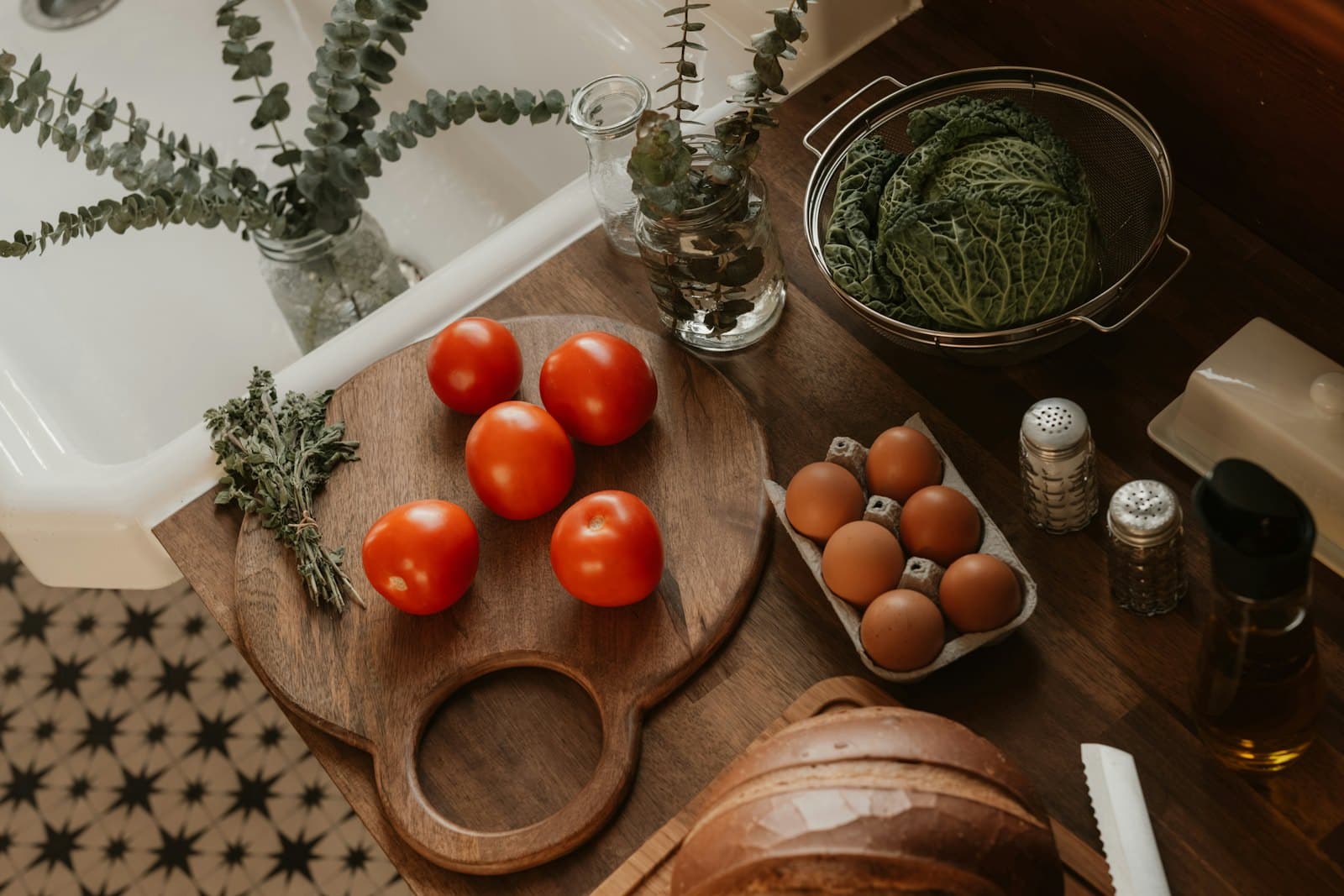 Tomatoes, eggs and vegetables on a kitchen worktop