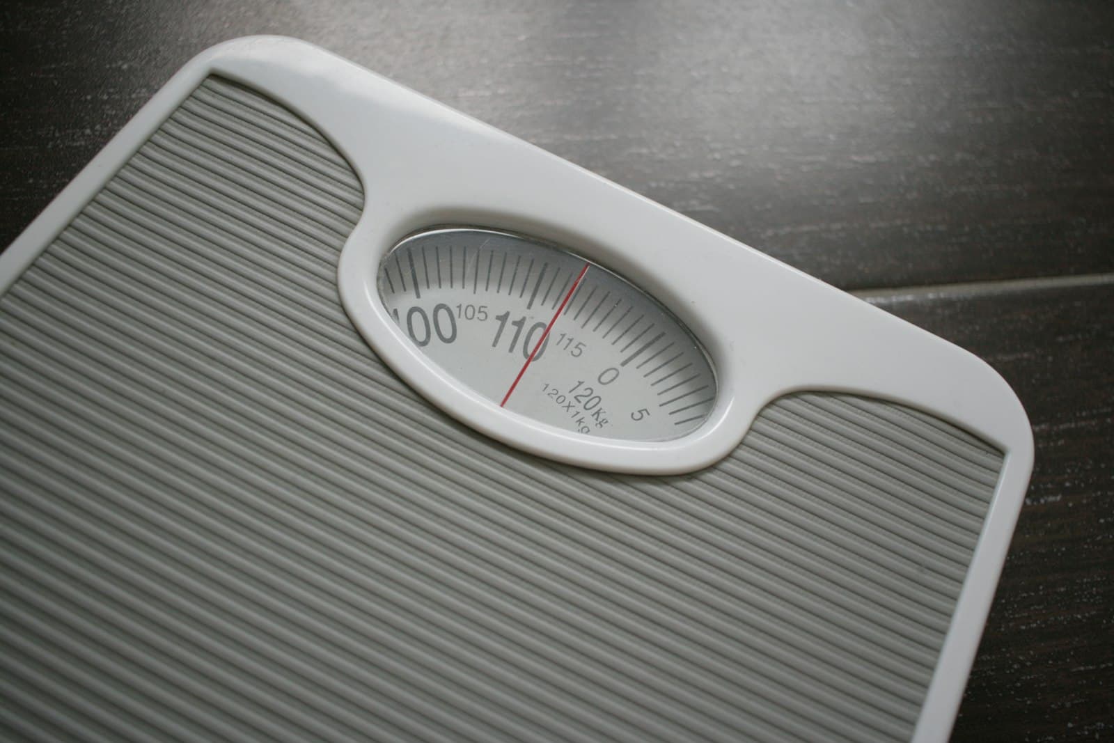 A bathroom scale on a wooden table
