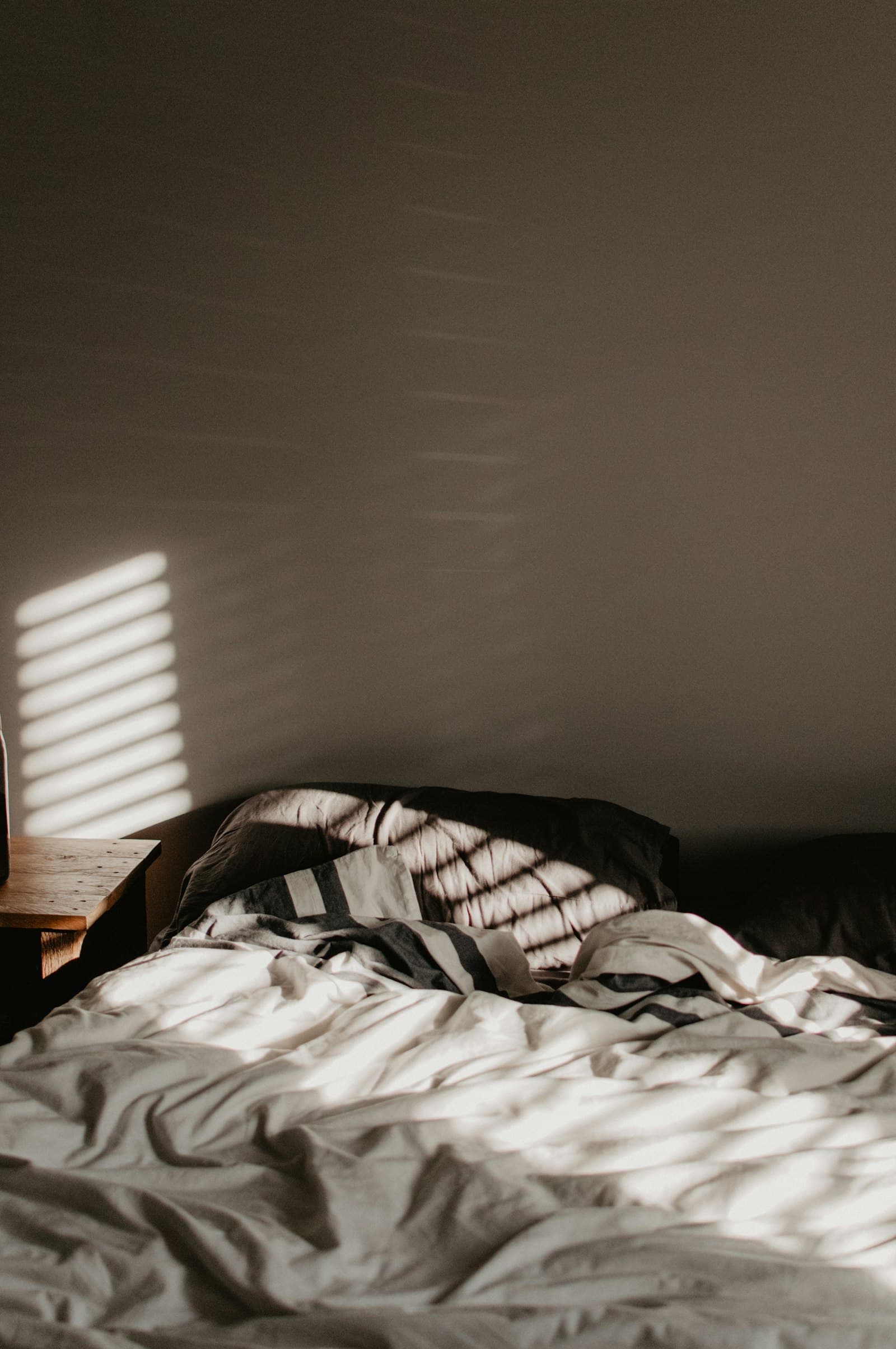 Soft morning light falling across a bed