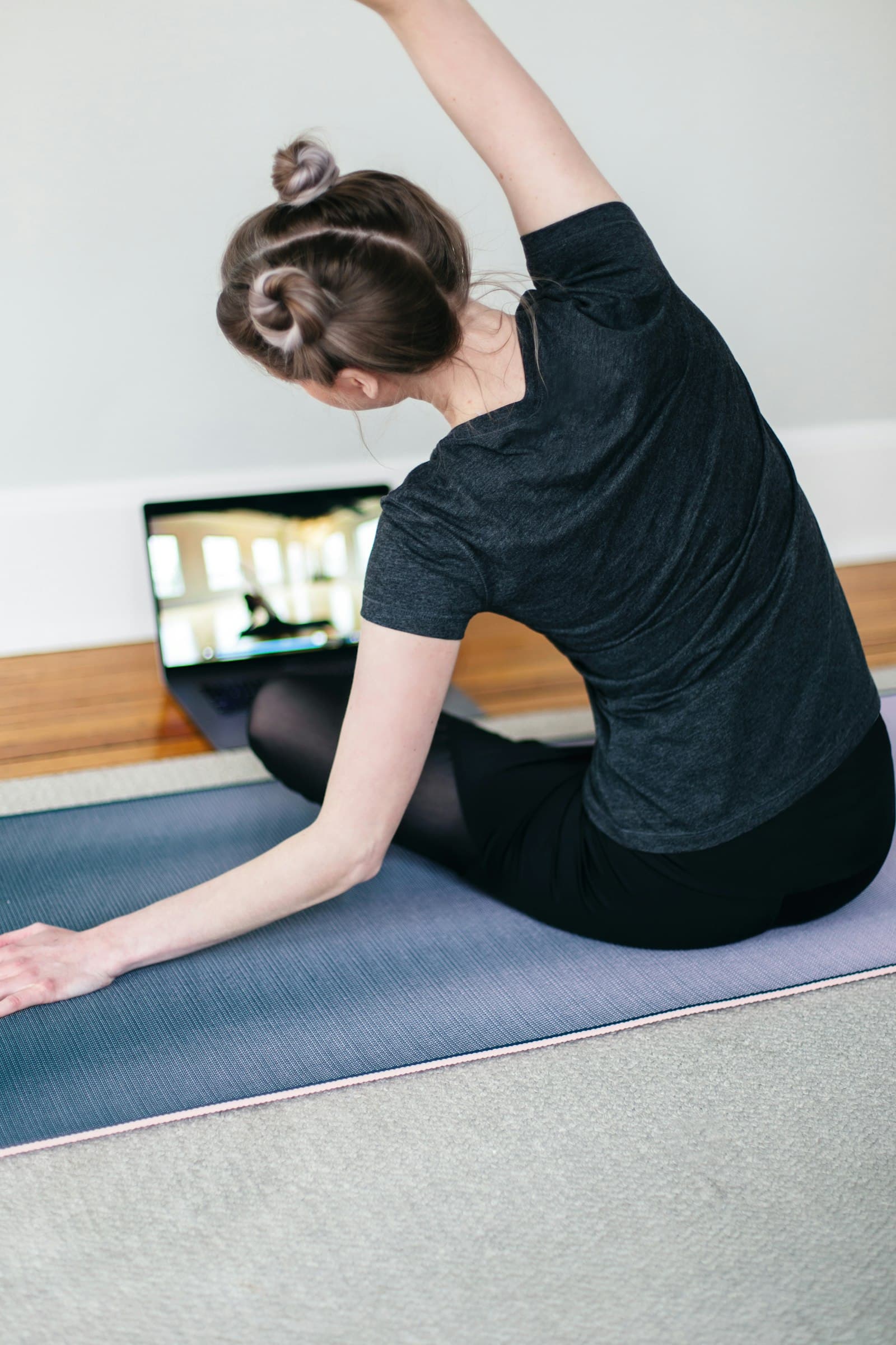 A person stretching on a yoga mat